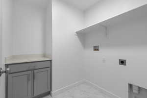 Laundry area with marble finish floor, baseboards, cabinet space, electric dryer hookup, and washer hookup