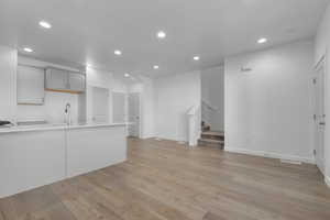 Interior space featuring light countertops, gray cabinets, light wood finished floors, and recessed lighting