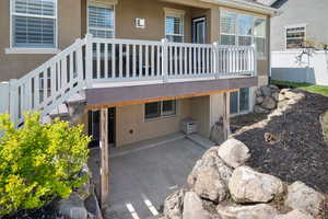 Exterior space with a patio area and stucco siding