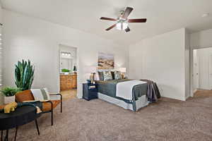Bedroom with baseboards, light carpet, a ceiling fan, and ensuite bath