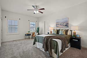 Carpeted bedroom featuring baseboards, ceiling fan, and visible vents