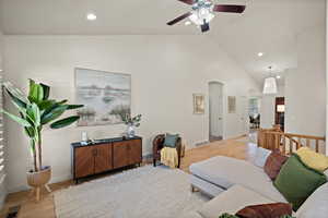 Living area featuring visible vents, light wood-style floors, ceiling fan, recessed lighting, and arched walkways