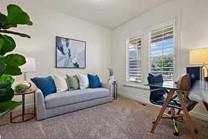 Home office featuring carpet flooring, baseboards, and visible vents