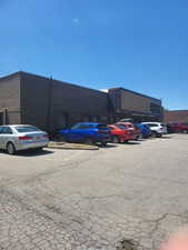 View of property featuring uncovered parking
