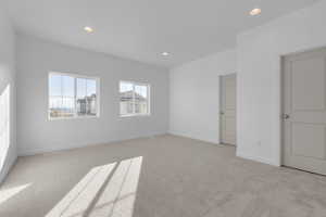 Unfurnished room with baseboards, light carpet, and recessed lighting
