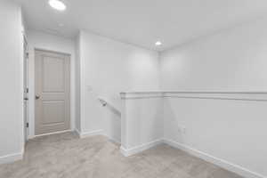 Walk in closet featuring visible vents and light colored carpet
