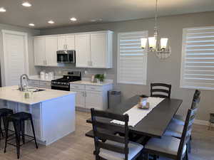 Kitchen featuring recessed lighting, a sink, light wood-style flooring, and appliances with stainless steel finishes