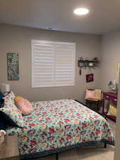 Carpeted bedroom featuring baseboards and visible vents