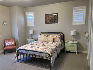 Carpeted bedroom with baseboards