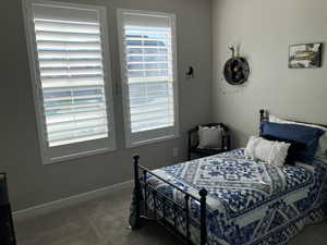 Bedroom with baseboards and carpet