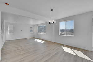 Interior space featuring an inviting chandelier, baseboards, and a wealth of natural light