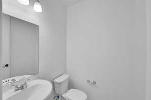 Half bath with a sink and toilet