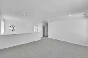 Unfurnished living room featuring recessed lighting, baseboards, and visible vents