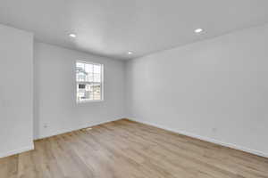 Unfurnished room with recessed lighting, baseboards, visible vents, and light wood-style floors