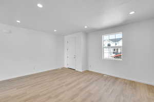 Spare room featuring recessed lighting, baseboards, light wood finished floors, and visible vents