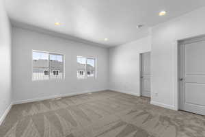 Unfurnished bedroom featuring a textured ceiling, carpet, recessed lighting, baseboards, and visible vents