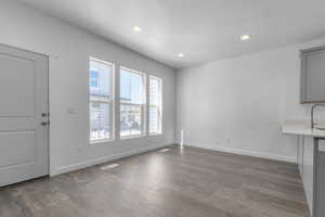 Interior space with recessed lighting, baseboards, hardwood / wood-style flooring, and a textured ceiling