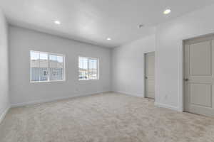 Interior space with carpet floors, recessed lighting, and baseboards