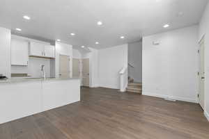Kitchen with a sink, baseboards, and recessed lighting