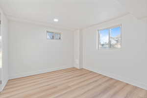 Basement featuring baseboards, recessed lighting, and wood finished floors