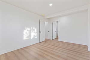 Spare room featuring baseboards, recessed lighting, and light wood-style flooring