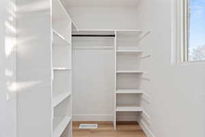 Spacious closet with visible vents and wood finished floors