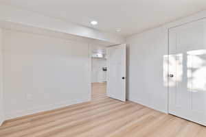 Unfurnished bedroom with baseboards, recessed lighting, and light wood-style flooring