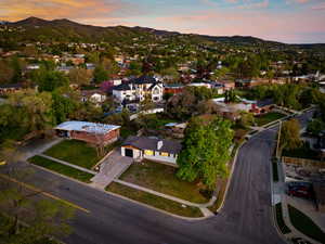 Aerial view at dusk featuring a residential view and a mountain view
