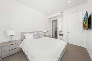 Carpeted bedroom with visible vents, recessed lighting, and baseboards