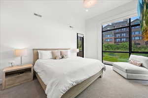 Carpeted bedroom with visible vents and recessed lighting