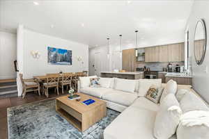 Living area featuring recessed lighting, dark wood-style flooring, and baseboards