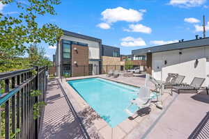 Community pool featuring fence and a patio