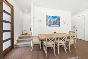Dining area with recessed lighting and wood finished floors
