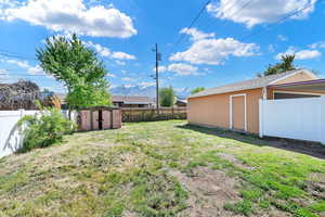 Fenced yard with garage view