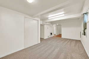 Basement family room with fresh paint and new carpet.