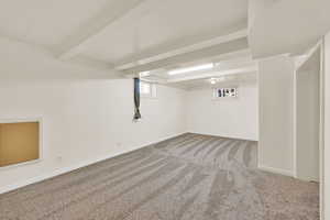 Basement family room with fresh paint and new carpet.