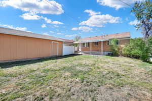 Yard with view of covered patio