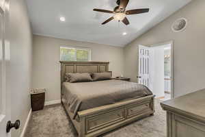 Bedroom with light colored carpet, recessed lighting, baseboards, lofted ceiling, and visible vents