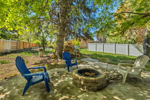 View of yard with a fenced backyard, a fire pit, and a patio area
