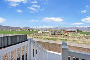 View of yard featuring a rural view, fence, and a mountain view