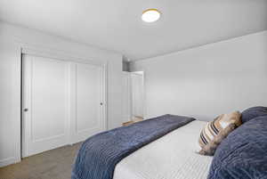 Bedroom featuring light colored carpet and a closet