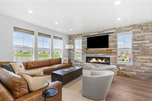 Living room with a fireplace, recessed lighting, and a wealth of natural light