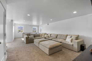Living room featuring recessed lighting, baseboards, and light carpet