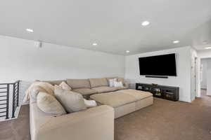Living area with recessed lighting, carpet flooring, and baseboards