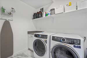 Laundry area with visible vents, cabinet space, baseboards, marble finish floor, and separate washer and dryer