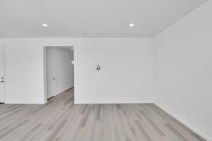 Unfurnished room with recessed lighting, baseboards, and light wood-type flooring