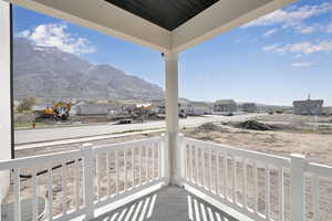 Balcony with a porch, a residential view, and a mountain view
