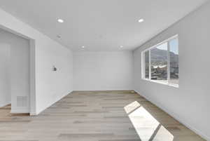 Spare room featuring visible vents, recessed lighting, a mountain view, and light wood finished floors