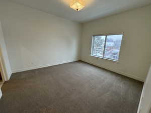 Unfurnished room featuring baseboards and carpet flooring
