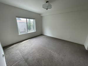 Unfurnished room featuring baseboards and carpet floors